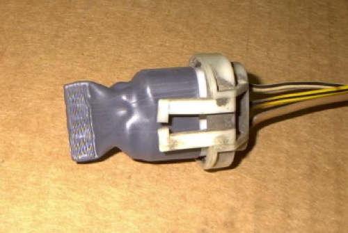 Figure 12 Original Headlight Plug Cover
